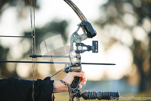 Image of Archery bow closeup and woman hands at shooting range for competition, game or learning in field or outdoor sports. Person with arrow for gaming, adventure and hunting with aim and target practice