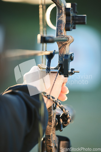 Image of Sports archer, hands and bow and arrow training for archery competition, athlete challenge or girl field practice. Shooting, talent and competitive woman focus on precision, aim or outdoor objective