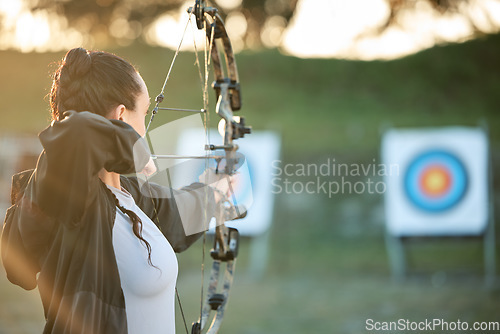 Image of Sports archer, target and bow and arrow training for archery competition, athlete challenge or girl field practice. Shooting, objective and competitive woman focus on precision, aim or mock up