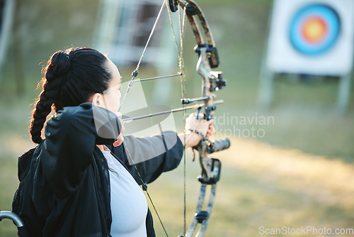 Image of Archery woman, target and bow and arrow training for outdoor sports, athlete challenge or girl field competition. Shooting goals, talent and competitive archer focus on precision, aim or objective