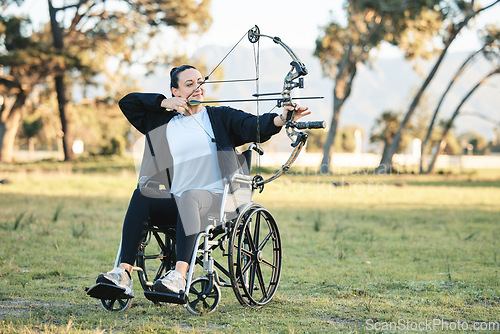 Image of Disabled woman, outdoor archery in wheelchair and challenge with active sports lifestyle in Canada. Person with disability in a park, fitness activity to exercise arms and aim arrow for hobby