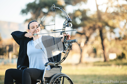 Image of Disabled sports woman, outdoor archery in wheelchair and challenge with active lifestyle in Canada. Person with disability in a park, fitness activity to exercise arms and aim arrow for hobby