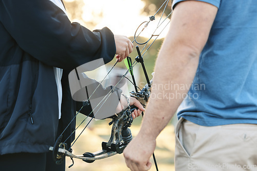 Image of Shooting range, bow and archery sports training with a woman and man outdoor for target practice. Hands of archer and athlete person for competition game or learning to aim, exercise and shoot arrow