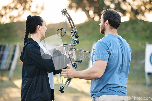 Image of Target, training and archery woman with an instructor on field for hobby, aim and control. Arrow, practice and archer people together outdoor for hunting, precision and weapon in shooting competition