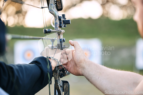 Image of Hands, archery coach and bow or arrow learning for archer competition, athlete focus challenge or girl training practice. Teacher, teaching and man coaching woman on sports, aim and target shooting