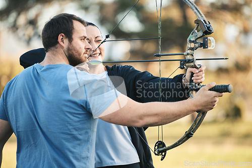 Image of Archery, bow and shooting range sports training with a woman and man outdoor for target practice. Archer and athlete person with focus on field for competition or game to aim arrow for action