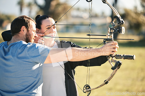 Image of Archery, aim and shooting range sports training with a woman and man outdoor for target practice. Archer and athlete person with focus on field for competition or game with bow and arrow for action