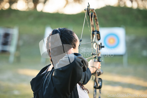 Image of Archery, shooting range and target for sports training with a woman outdoor for bow practice. Archer athlete person with focus on field for competition or game to aim arrow for action and bullseye