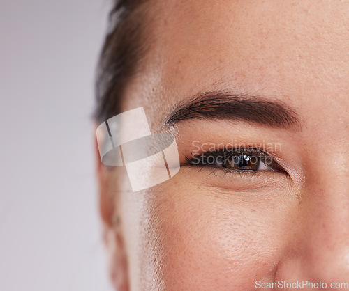 Image of Smile, skincare and half portrait of woman with eye zoom, glowing skin and natural beauty makeup in studio. Dermatology, advertising and luxury cosmetics, face of model isolated on studio background.