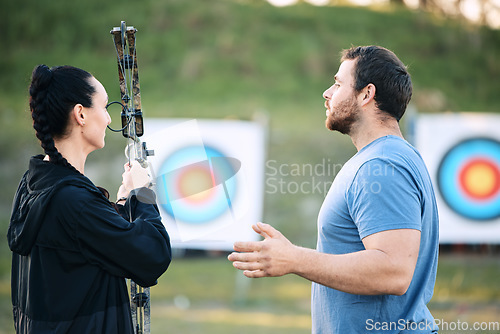 Image of Sports, archery coach or bow and arrow learning for archer competition, athlete challenge or girl training practice. Teacher, teaching talk or man coaching woman on precision, aim and target shooting