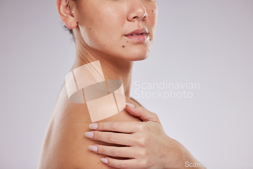 Image of Skincare, closeup body and woman shoulder for aesthetic wellness, cosmetics or self love on studio background. Beauty model touch soft skin for healthy shine, salon transformation or dermatology glow