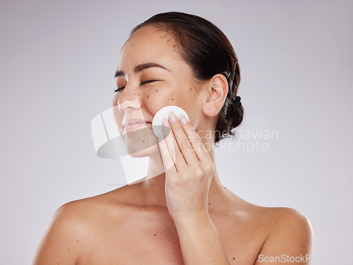 Image of Face, makeup cotton and woman with eyes closed in studio isolated on a gray background. Skincare hygiene, beauty aesthetics and happy female model with facial pad or product for cleaning cosmetics.