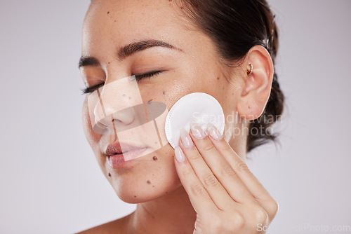 Image of Skincare cotton, face and woman with eyes closed in studio isolated on gray background. Makeup hygiene, beauty aesthetics and closeup of female model with facial pad or product for cleaning cosmetics