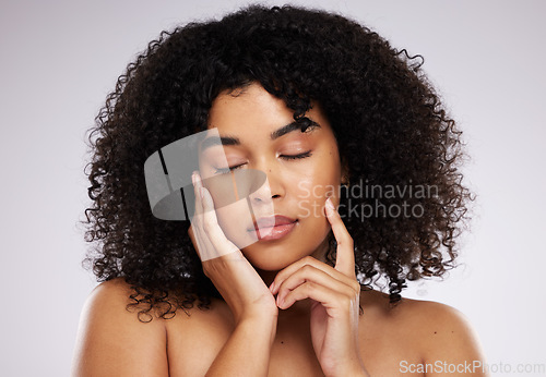 Image of Dermatology, cosmetics and black woman with eyes closed, hand on face and afro, advertising luxury makeup. Skincare, beauty and facial skin care product promo on model isolated on studio background.