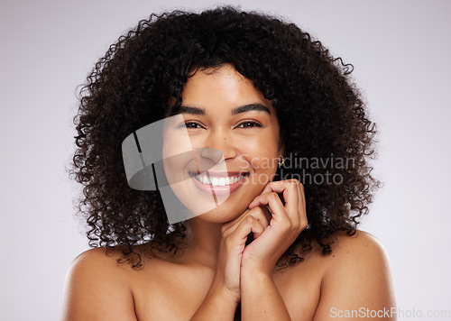 Image of Portrait, beauty and hair with a biracial woman in studio on a gray background for natural afro treatment. Face, skincare and haircare with an attractive young female posing to promote cosmetics
