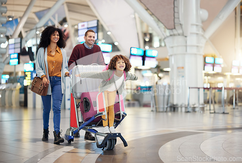 Image of Airport, family and child excited for flight with suitcase trolley on holiday, vacation or immigration journey and travel. Luggage of mother, father or diversity parents with girl kid flying in lobby