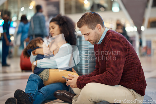 Image of Phone, tired and interracial family waiting at the airport for a delayed flight. Contact, late and man on a mobile app with a black woman and child sleeping during problems with travel on a trip