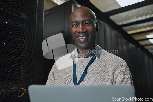 Image of Laptop, portrait and IT black man in server room for research, engineer working in dark data center lobby. Face, cybersecurity or analytics with male programmer problem solving or troubleshooting
