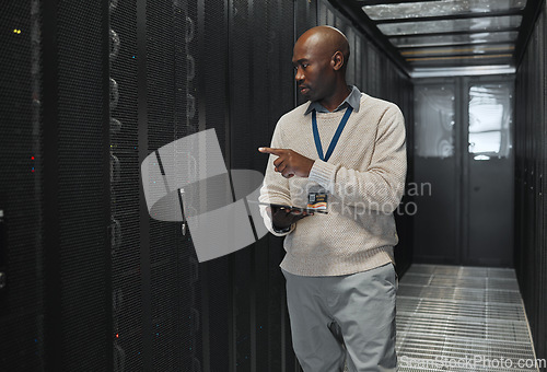 Image of Tablet, network management and IT black man for software update, working on code in dark server room. Computer, cybersecurity and male programmer with tech for problem solving or troubleshooting