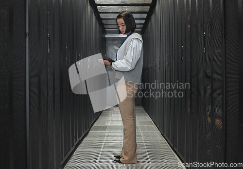 Image of Tablet, server room and programming with a developer asian woman at work on a computer mainframe. Software, database and information technology with a female coder working alone on a cyber network