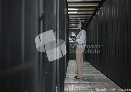 Image of Tablet, server room and storage with a programmer asian woman at work on a computer mainframe. Software, database and information technology with a female coder working alone on a cyber network