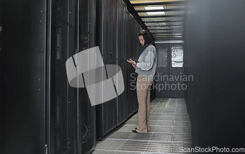 Image of Tablet, server room and data center with a programmer asian woman at work on a computer mainframe. Software, database and information technology with a female coder working alone on a cyber network