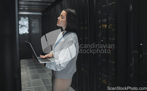 Image of Server room, laptop and young woman or technician in data center management, system and cyber security. Thinking, serious and inspection of asian electrician, engineer or programmer person code check