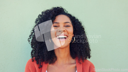 Image of Smile, laughing and happy black woman on green wall background. Portrait face of funny, young and comedy young female with natural afro hair, freedom and happiness for life, motivation and crazy joke