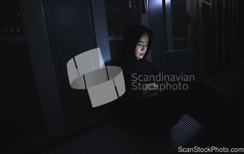 Image of Hacking, laptop and hacker woman in dark server room for coding software, data center crime or cyberpunk intel. Network criminal, person or user in cybersecurity, information technology or ransomware