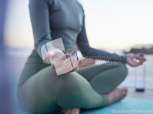 Image of Woman, hands and yoga in meditation for zen, spiritual wellness or calm exercise on the beach. Hand of female yogi meditating for peaceful healing, lotus pose or fitness in awareness on mat by ocean