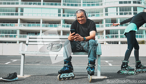 Image of Fitness, roller blade and senior man with smartphone, smile and guy on bench, headphones and relax. Exercise, mature male and gentleman outdoor, skater and cellphone for social media, music and break