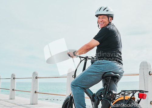 Image of Electric bike, portrait or travel with a senior man on a promenade, riding eco friendly transport by the beach. Sustainability, cycling or mock up with a mature male tourist by the seaside for a ride