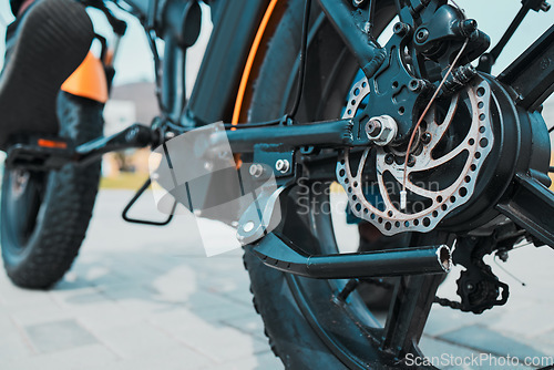 Image of Gear, metal or electrical bike wheel in city transportation, future clean energy or sustainability cycling travel. Zoom, ebike or eco friendly bicycle and equipment, part or electricity battery motor