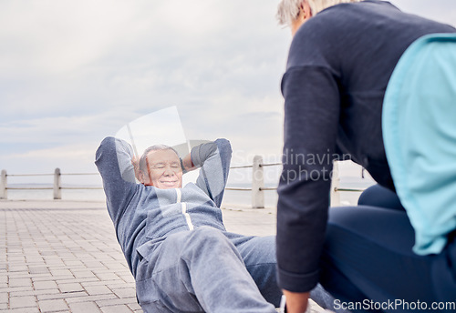 Image of Fitness, exercise and sit ups with a senior couple training outdoor together for an active lifestyle of wellness. Workout, health or core with a mature man and woman outside on the promenade