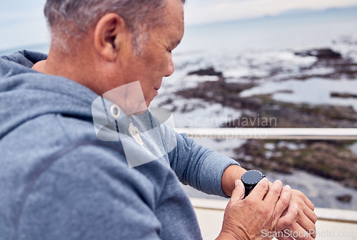 Image of Smart watch, man and sports exercise at beach promenade of fitness, training or runner wellness. Stopwatch, senior person and workout time of heart rate, monitor healthy progress or data app by ocean