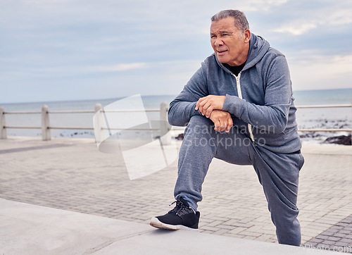 Image of Senior man, fitness and stretching at beach sidewalk for energy, wellness and healthy cardio workout. Elderly male, exercise and rest at seaside promenade for training, sports and breathing outdoor