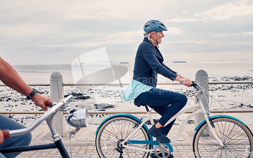 Image of Old woman on bike at beach, fitness and cycling outdoor, vitality and health, retirement activity by ocean. Cyclist, bicycle and sustainable transport, eco friendly and carbon footprint with hobby