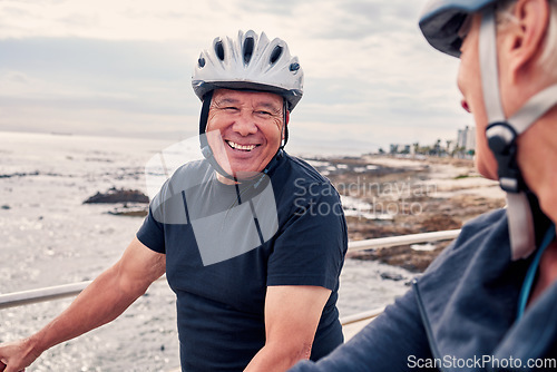 Image of Bike, cycling and beach with a old couple riding outdoor on the promenade during summer for exercise. Bicycle, fitness or leisure with a senior man and woman taking a ride together on their bikes