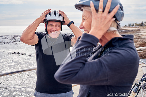 Image of Helmet, funny and a senior couple cycling outdoor together for fitness or an active lifestyle. Summer, exercise or humor with a mature man and woman laughing at a joke on the promenade during a cycle