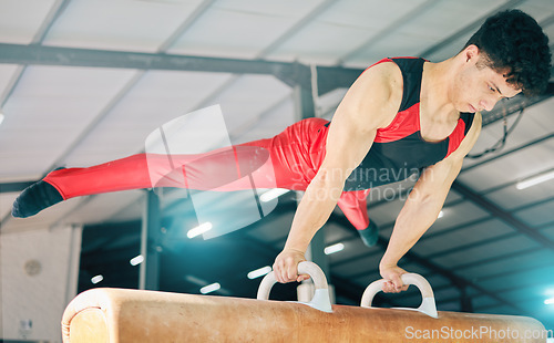 Image of Horse, gymnastics and exercise with a sports man training for an olympics event or competition. Fitness, balance and games with a male athlete or gymnast in a studio or gym for competitive sport