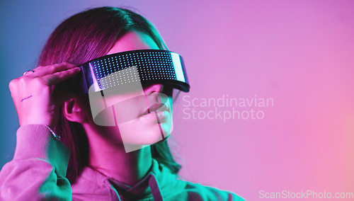 Image of Virtual reality, cyberpunk and mockup, woman in goggles in online metaverse app, game or video on neon purple background. Vr, ar and ux, future fashion digital glasses on model in studio with space.