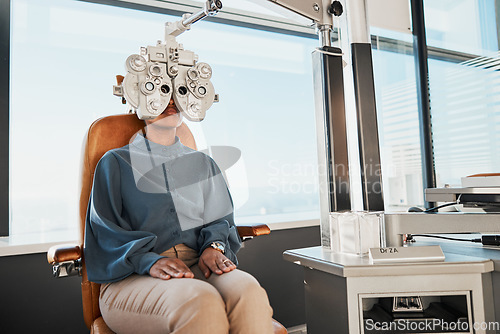 Image of Ophthalmologist phoropter, patient consulting or eye exam for vision, healthcare or wellness. Black woman, ophthalmology care and health for eyes in office, hospital or store for vision assessment