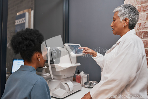 Image of Digital eye exam, vision and health for eyes, optometry and doctor with patient, eyecare and ophthalmology clinic. Machine, screen and black woman with senior optometrist, service and medical exam