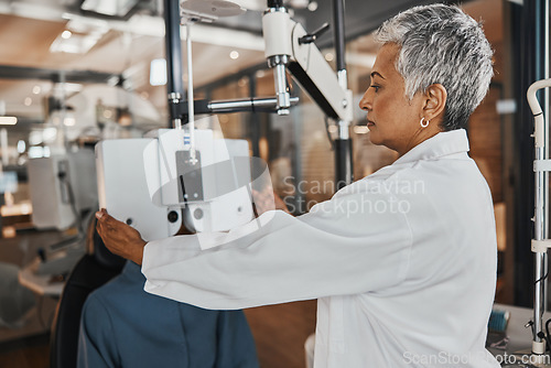 Image of Eye exam, optometry and optometrist woman for vision consultation, medical or healthcare lens expert. Eyes check or consulting client, person or patient with professional doctor and phoropter machine