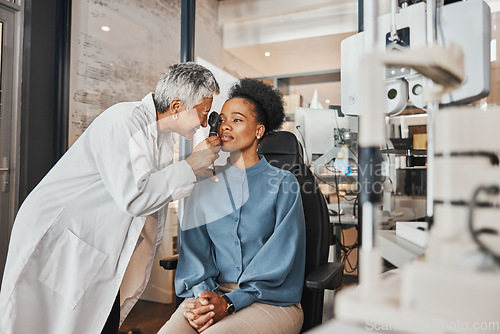 Image of Doctor, vision or black woman in eye exam consultation or assessment for eyesight at optometrist office. Mature or senior optician helping a customer testing or checking iris or retina visual health
