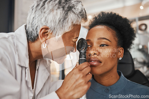 Image of Doctor, vision or black woman in eye exam assessment consultation for eyesight at optometrist office. Mature or senior optician helping a customer testing or checking iris or retina visual health