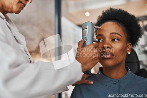 Image of Face, eye exam or black woman consulting doctor for eyesight at optometrist or ophthalmologist. African customer testing vision with hands of optician helping or testing iris or retina visual health