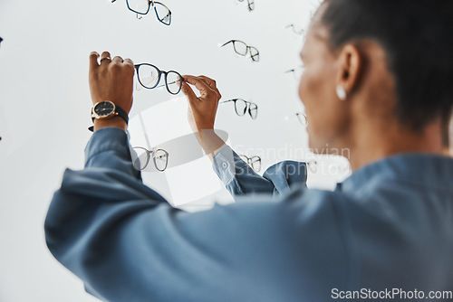 Image of Optometry, eye care and female choosing frame for her prescription lenses at optical store. Healthcare, ophthalmology and African woman patient shopping for new glasses or spectacles at optic clinic