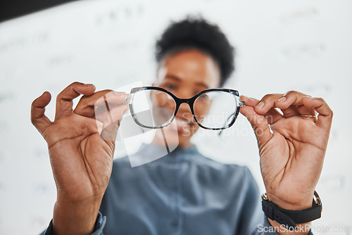 Image of Glasses, black woman hands and customer with store worker at optician clinic looking at lens. Consulting, smile and eyewear shopping in a frame shop for vision test and prescription exam for eyes