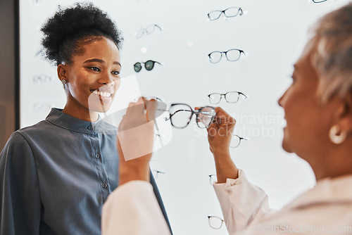 Image of Vision, optician and black woman shopping for glasses in optometry store or shop for ophthalmology. Doctor, healthcare and happy female or medical ophthalmologist with eyewear or lenses for eye care.